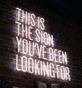 "This is the sign you've been looking for" neon sign.